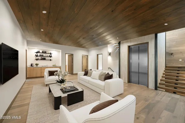 a living room with furniture wooden floor and a flat screen tv