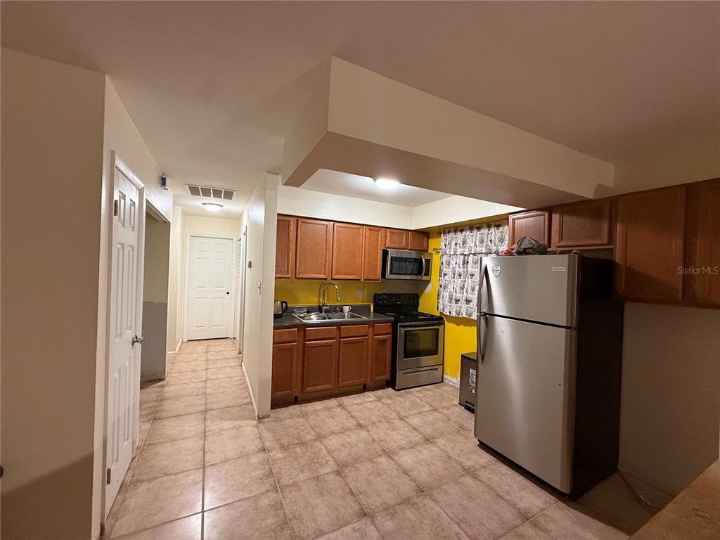 9302 Southeast Maricamp Road Ocala, FL 34472 - Photo 11 of 40 a kitchen with a refrigerator and a stove