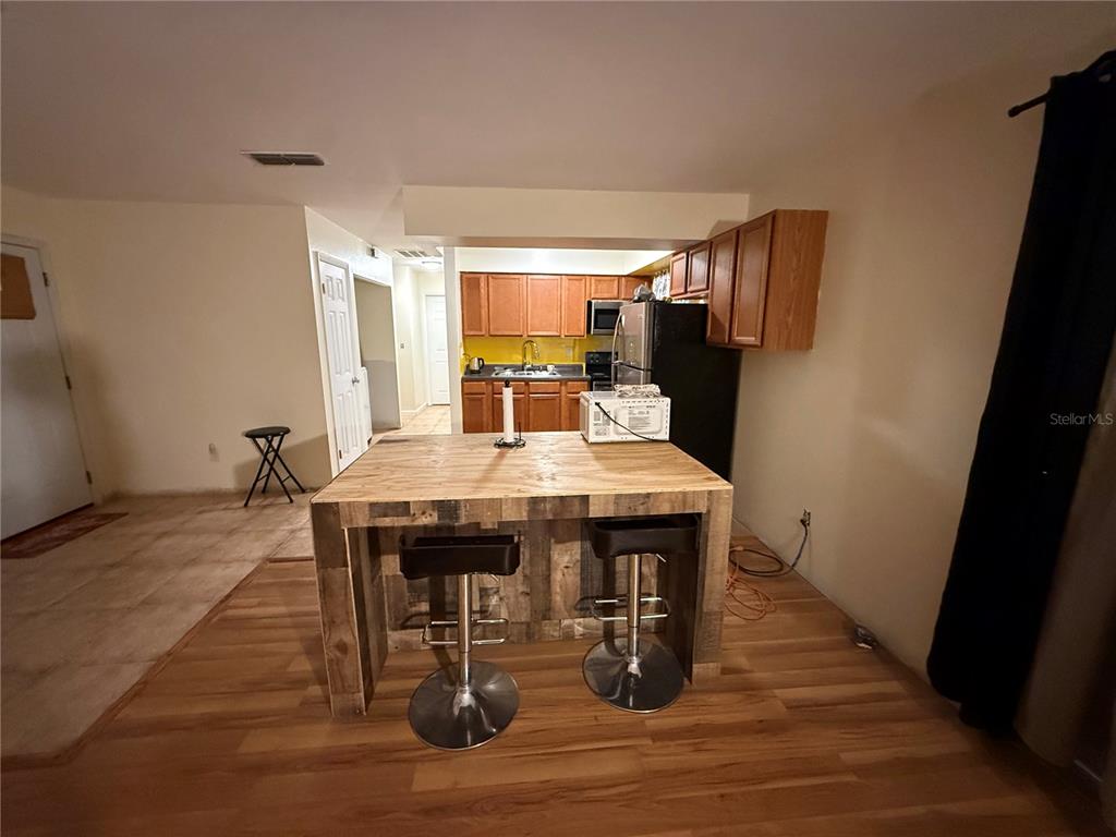 9302 Southeast Maricamp Road Ocala, FL 34472 - Photo 13 of 40 a view of a dining room with furniture and wooden floor