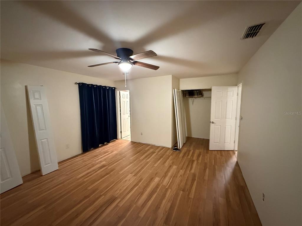 9302 Southeast Maricamp Road Ocala, FL 34472 - Photo 17 of 40 a view of an empty room with closet and wooden floor