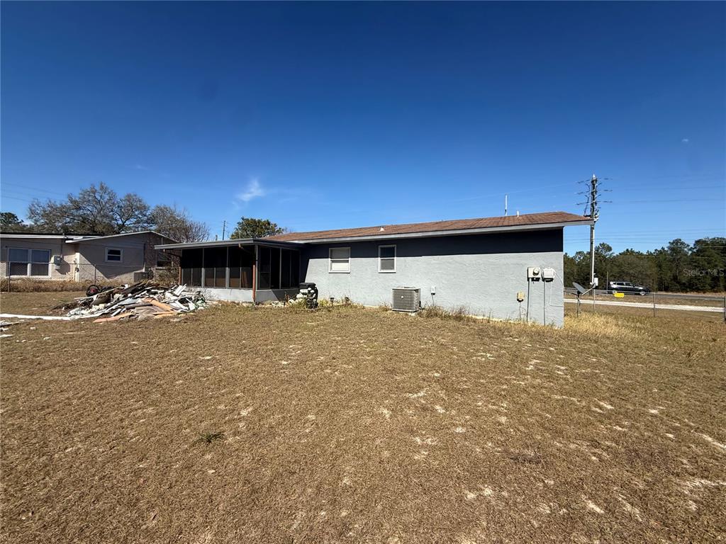 9302 Southeast Maricamp Road Ocala, FL 34472 - Photo 39 of 40 a view of a house with a yard