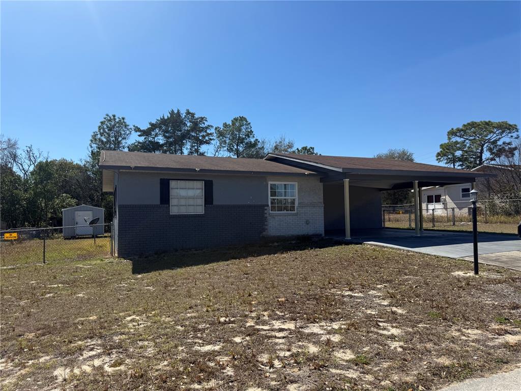 9302 Southeast Maricamp Road Ocala, FL 34472 - Photo 4 of 40 a front view of house with yard and trees in the background