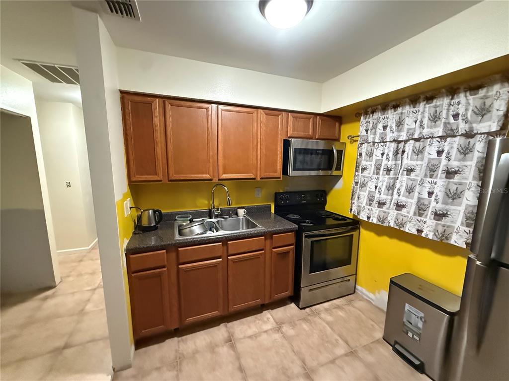 9302 Southeast Maricamp Road Ocala, FL 34472 - Photo 10 of 40 a kitchen with stainless steel appliances granite countertop a stove a sink and a refrigerator