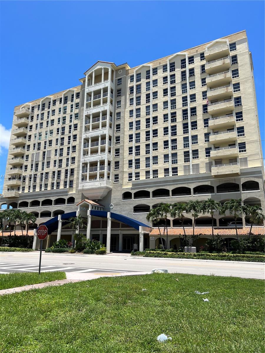 2351 Douglas Road, Unit 910 Miami, FL 33145 - Photo 1 of 24 a front view of a building with a yard