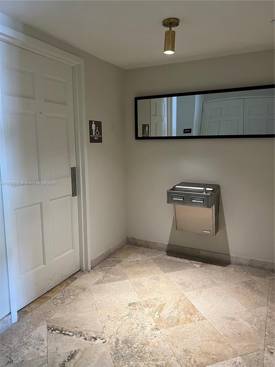2351 Douglas Road, Unit 910 Miami, FL 33145 - Photo 13 of 24 a view of a livingroom with wooden floor and a ceiling fan