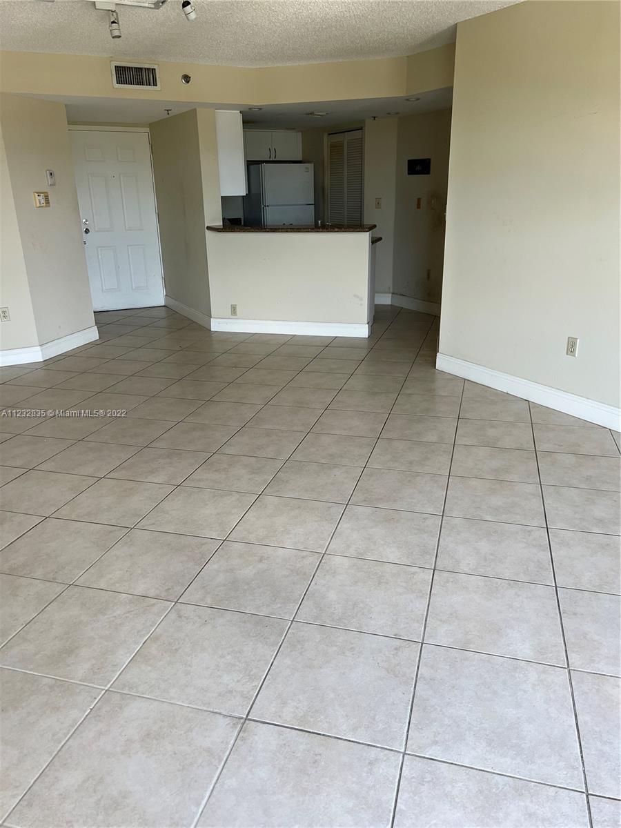 2351 Douglas Road, Unit 910 Miami, FL 33145 - Photo 18 of 24 a view of a kitchen with a sink and a stove