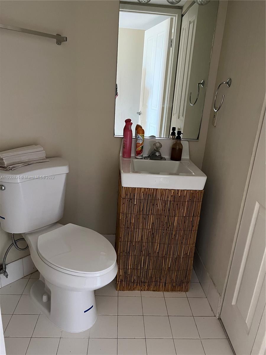 2351 Douglas Road, Unit 910 Miami, FL 33145 - Photo 20 of 24 a bathroom with a toilet and a sink