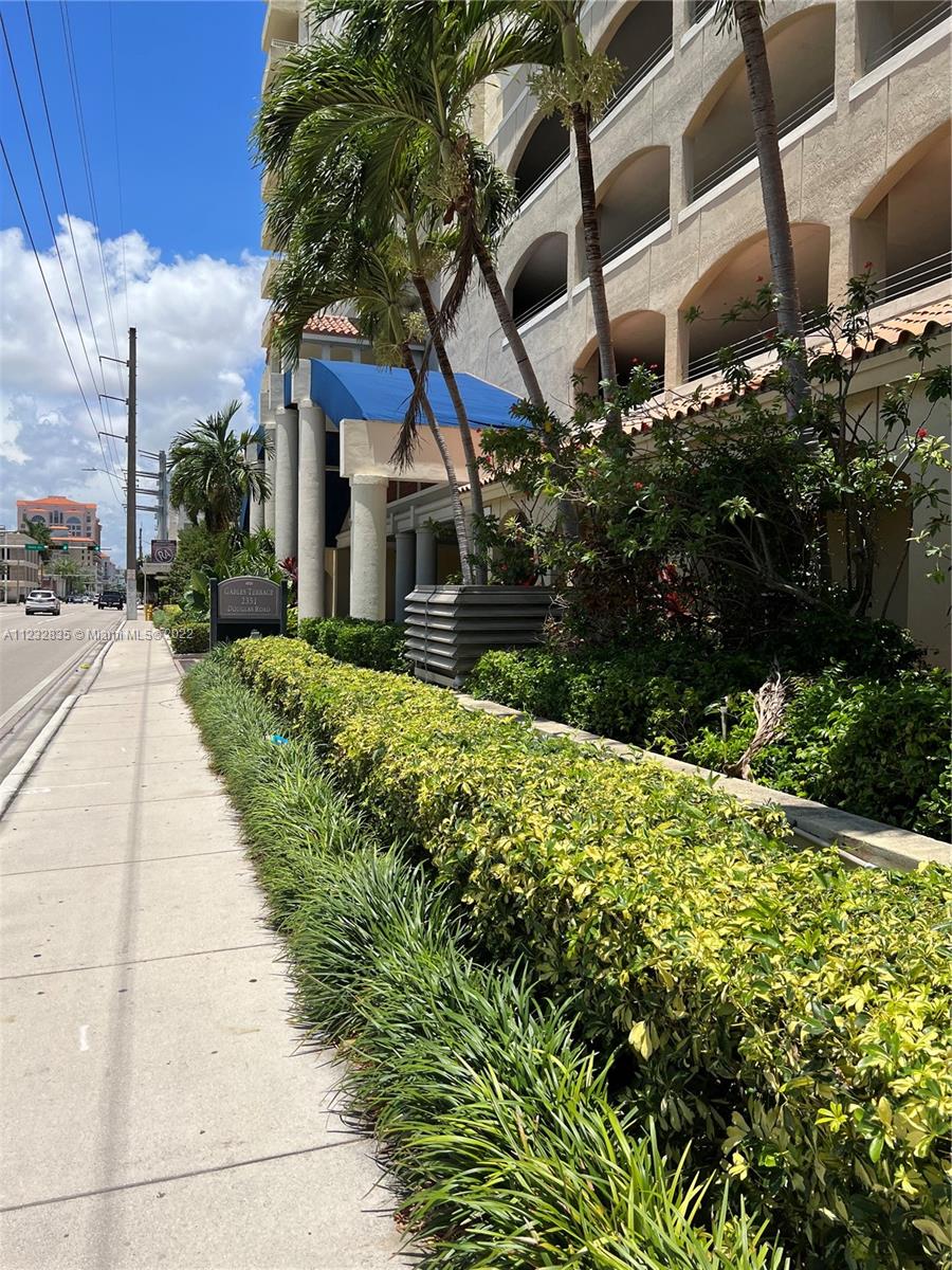 2351 Douglas Road, Unit 910 Miami, FL 33145 - Photo 3 of 24 a view of house with yard and green space