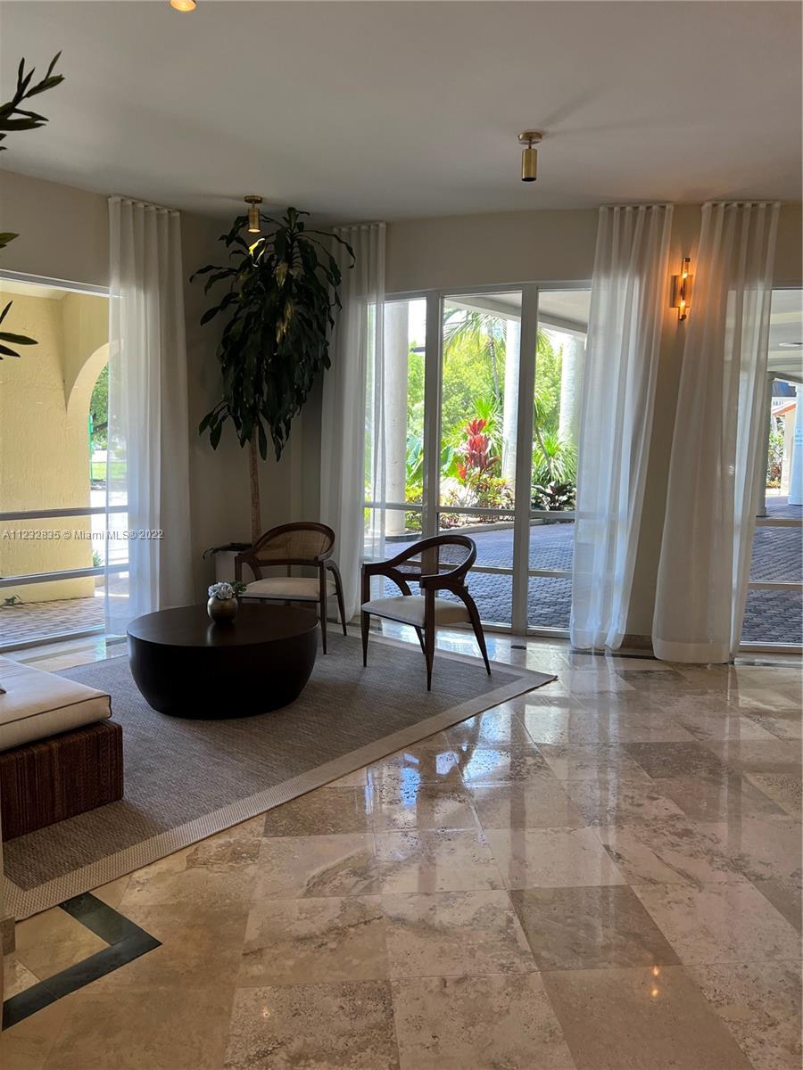 2351 Douglas Road, Unit 910 Miami, FL 33145 - Photo 8 of 24 a living room with furniture and a large window