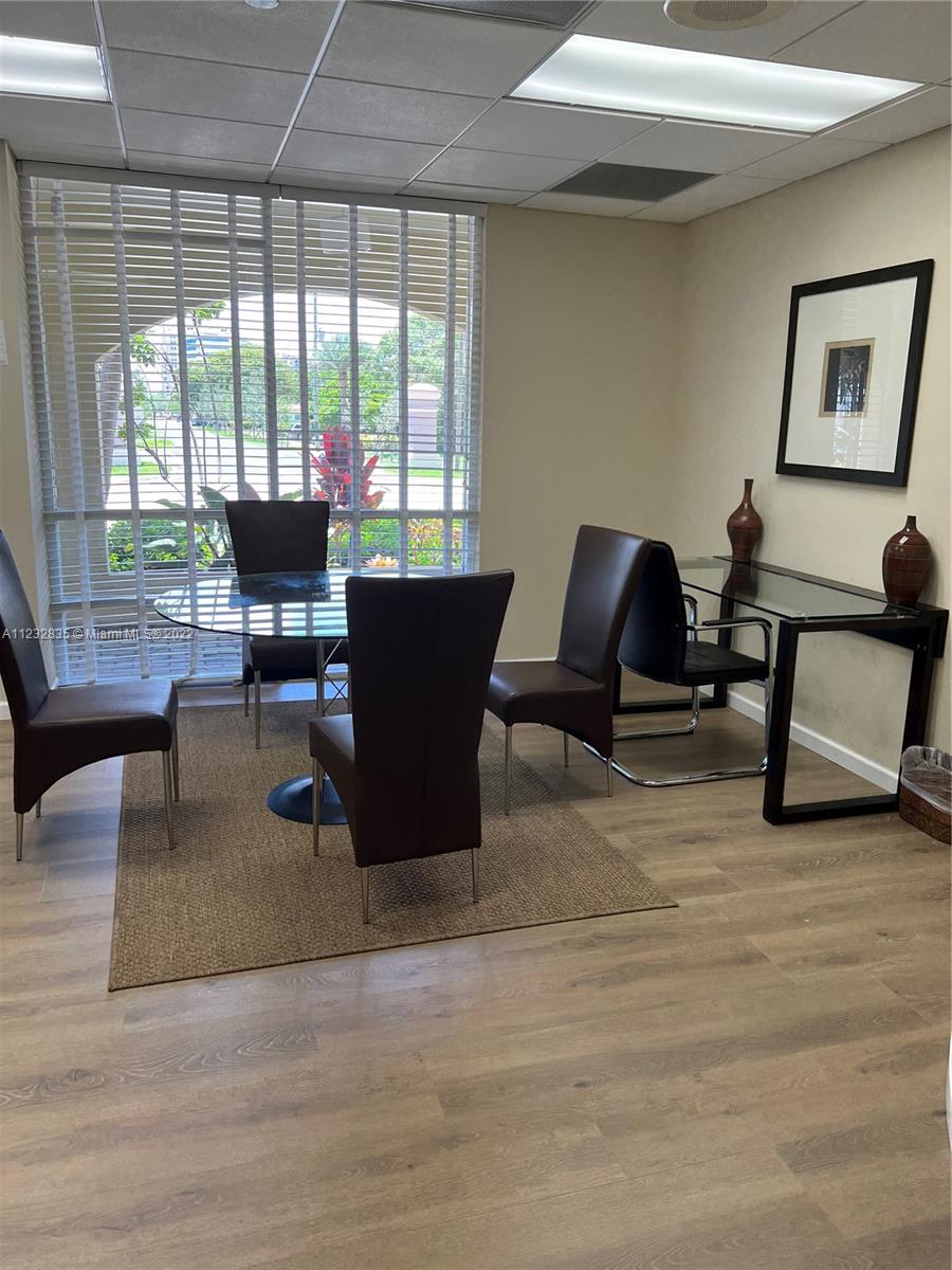 2351 Douglas Road, Unit 910 Miami, FL 33145 - Photo 10 of 24 a living room with furniture a large window and a potted plant