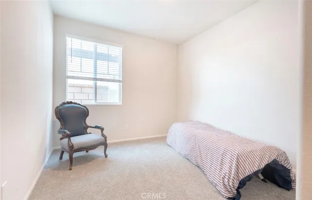 a bedroom with a bed and chair