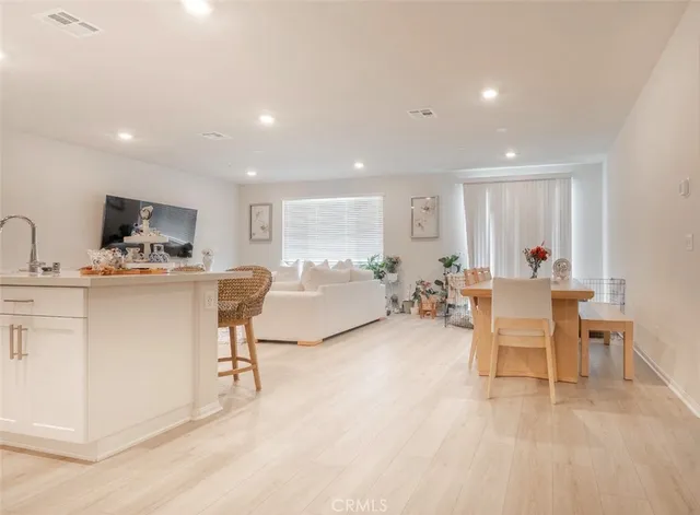 a living room with furniture a window and a table