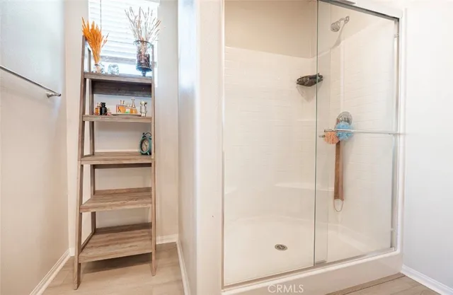 a bathroom with a glass shower door