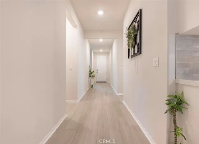 a view of a hallway with paintings on the wall