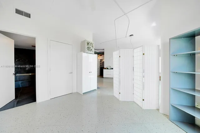 a view of a kitchen with refrigerator and cabinet