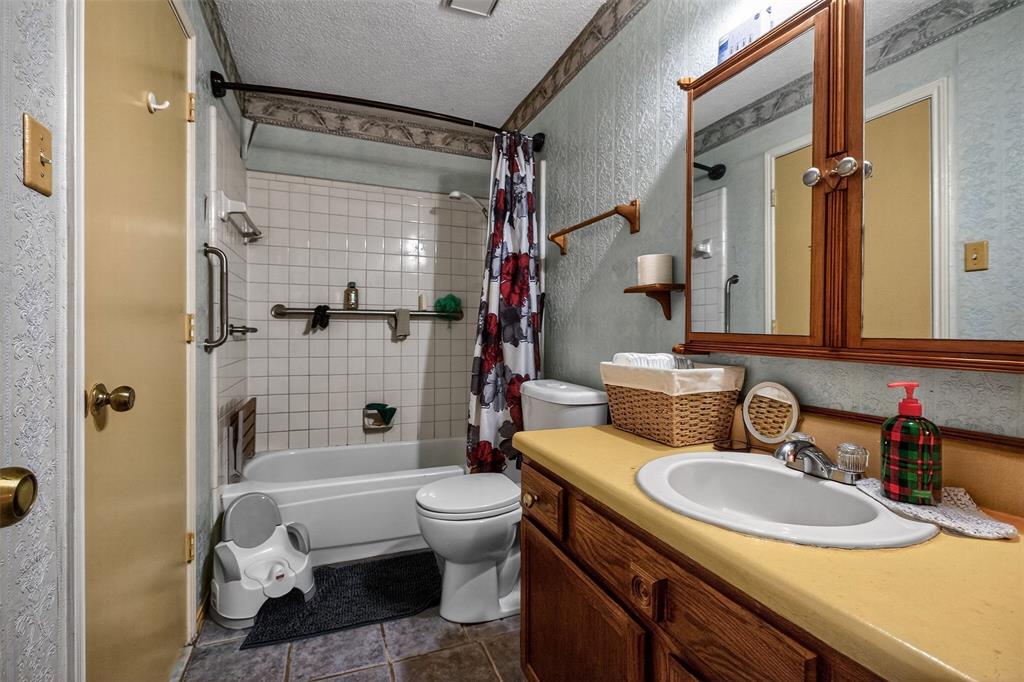 6813 Haltom Road Fort Worth, TX 76137 - Photo 11 of 14 a bathroom with a sink toilet tub and shower