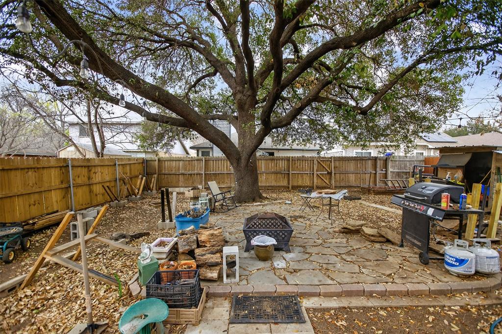 6813 Haltom Road Fort Worth, TX 76137 - Photo 13 of 14 a view of a patio with table and chairs and potted plants