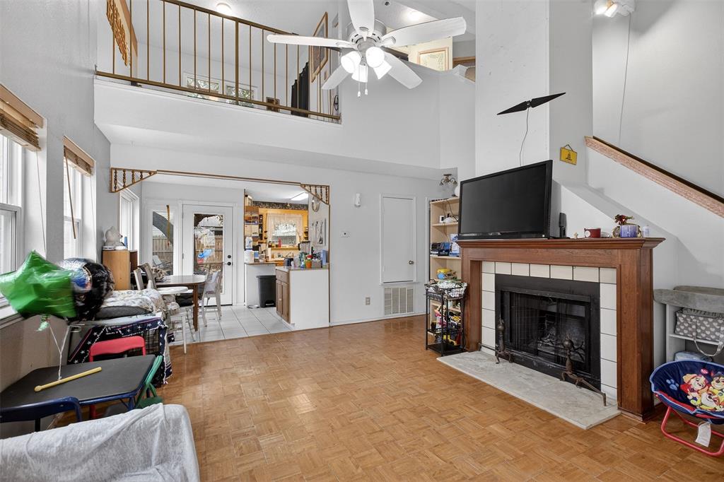 6813 Haltom Road Fort Worth, TX 76137 - Photo 3 of 14 a living room with furniture a fireplace and a flat screen tv