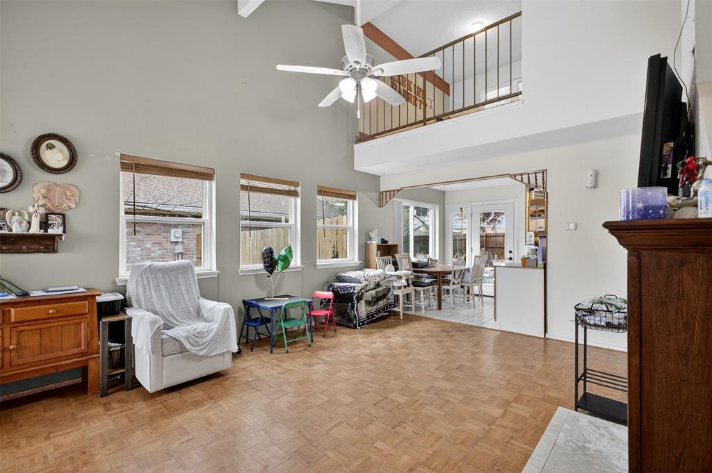 6813 Haltom Road Fort Worth, TX 76137 - Photo 4 of 14 a living room with furniture a flat screen tv and a window