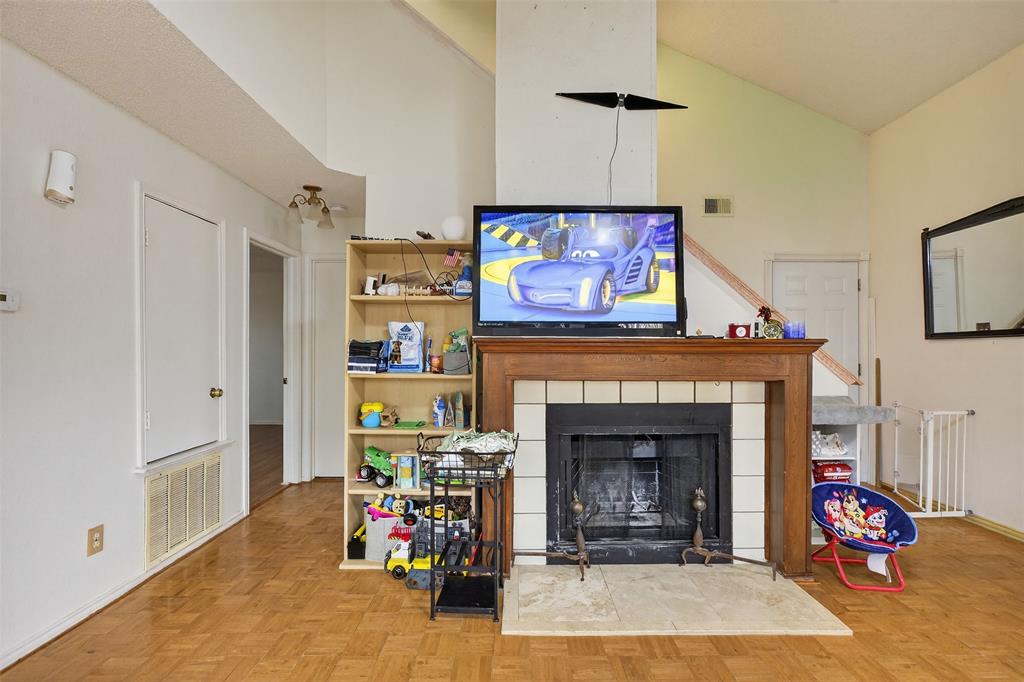 6813 Haltom Road Fort Worth, TX 76137 - Photo 5 of 14 a living room with furniture and a fireplace