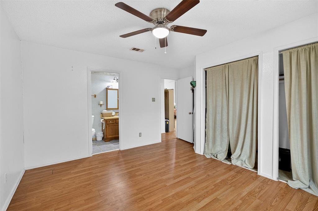6813 Haltom Road Fort Worth, TX 76137 - Photo 7 of 14 a view of a big room with wooden floor and a ceiling fan