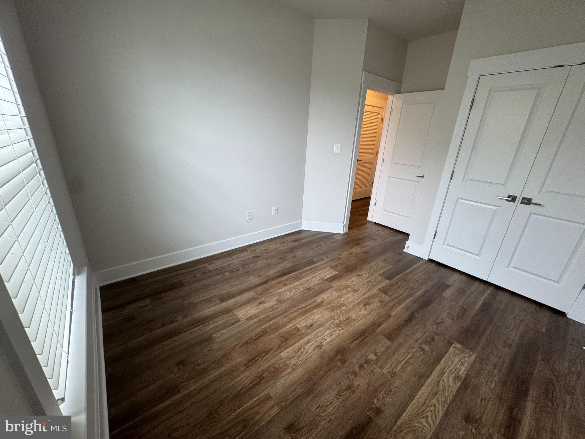 2928 Osprey Way North Frederick, MD 21701 - Photo 3 of 15 a view of an empty room with wooden floor and a window