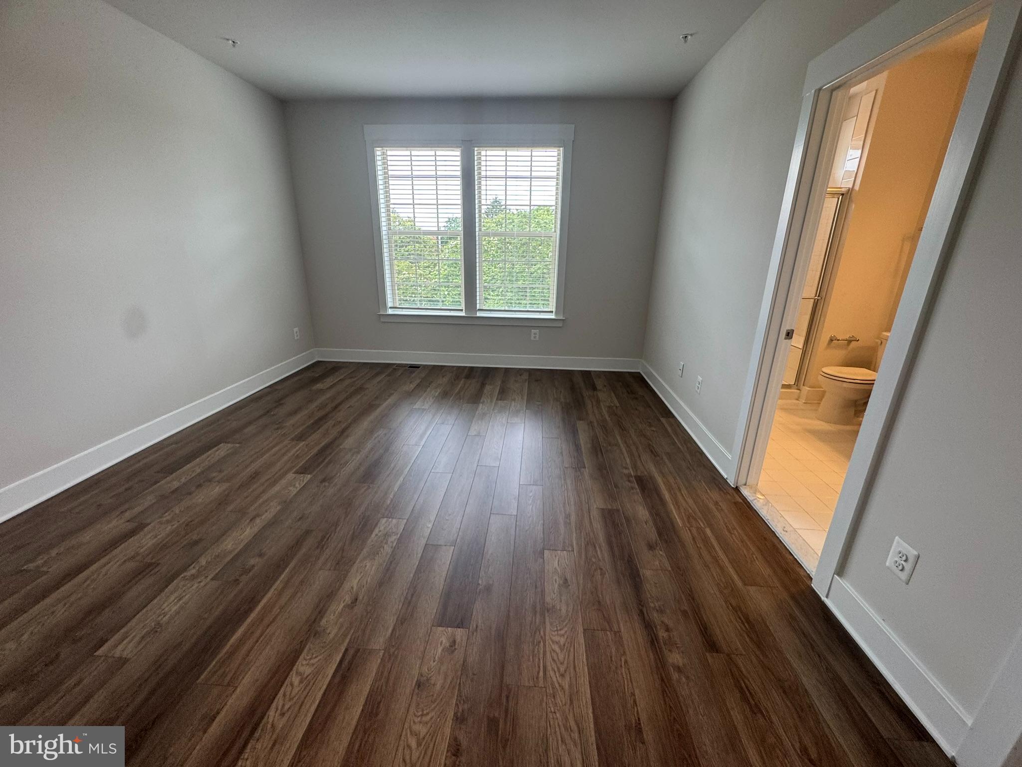 2928 Osprey Way North Frederick, MD 21701 - Photo 8 of 15 an empty room with wooden floor and windows