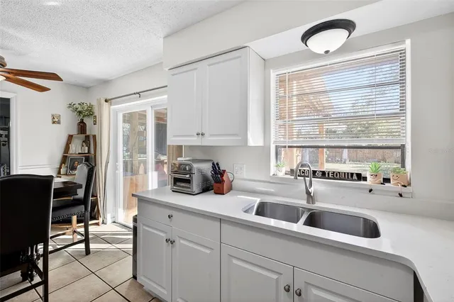 a kitchen with a sink cabinets and window
