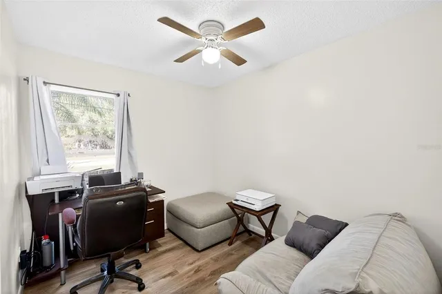 a view of a livingroom with workspace and a window