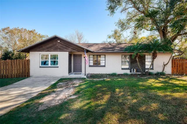 a backyard of a house with table and chairs