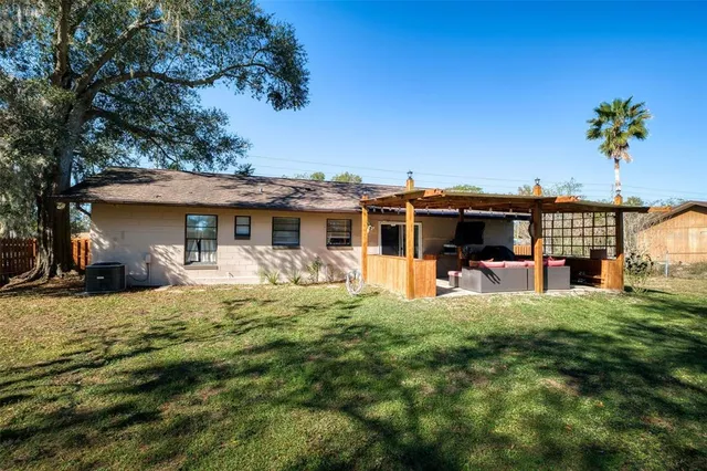 a view of a house with backyard sitting area and garden