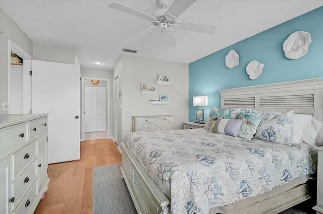 a bedroom with a large bed and a chandelier