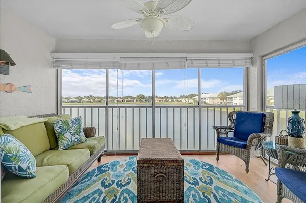 a living room with furniture and a floor to ceiling window