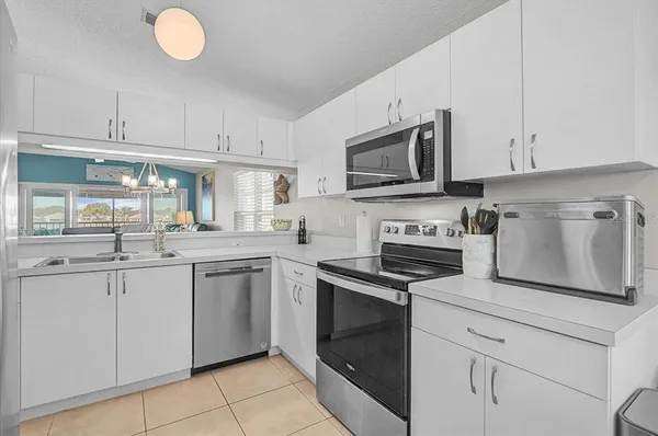 a kitchen with cabinets stainless steel appliances and a sink