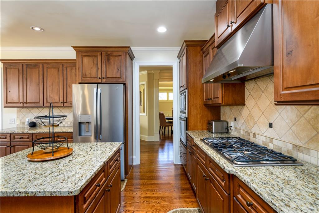 2070 Trinity Mill Drive Dacula, GA 30019 - Photo 12 of 46 a kitchen with stainless steel appliances granite countertop a stove top oven a refrigerator a sink and dishwasher