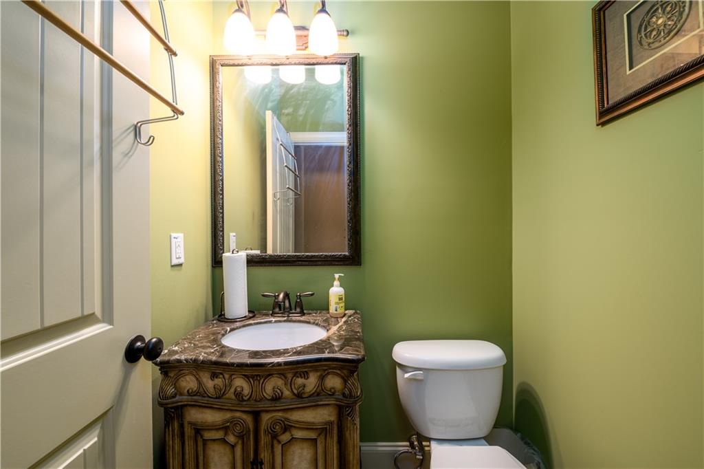 2070 Trinity Mill Drive Dacula, GA 30019 - Photo 17 of 46 a bathroom with a granite countertop sink a mirror and a toilet