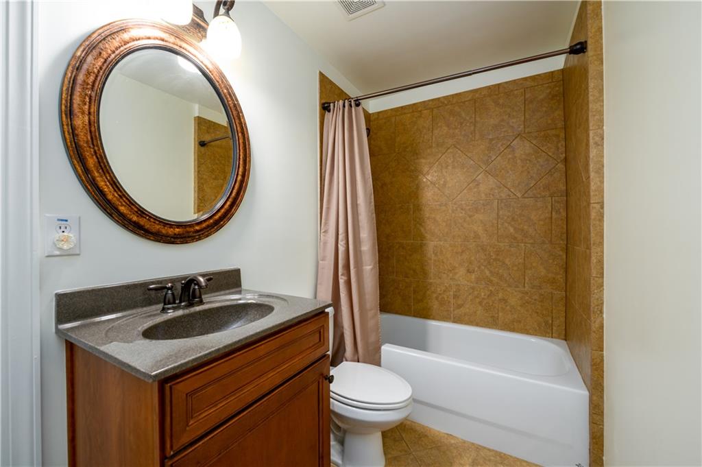 2070 Trinity Mill Drive Dacula, GA 30019 - Photo 25 of 46 a bathroom with a sink a toilet and a mirror