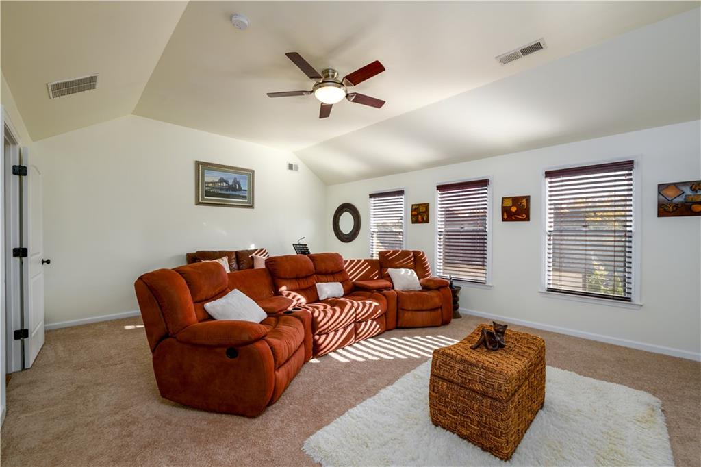 2070 Trinity Mill Drive Dacula, GA 30019 - Photo 31 of 46 a living room with furniture ceiling fan and a window