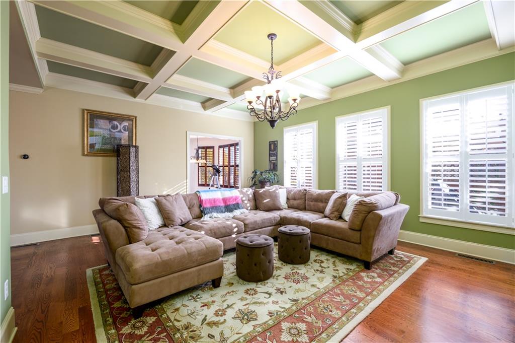 2070 Trinity Mill Drive Dacula, GA 30019 - Photo 7 of 46 a living room with furniture wooden floor and a chandelier