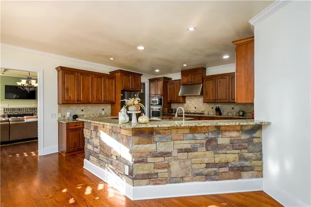 a bathroom with a granite countertop sink a mirror and a toilet