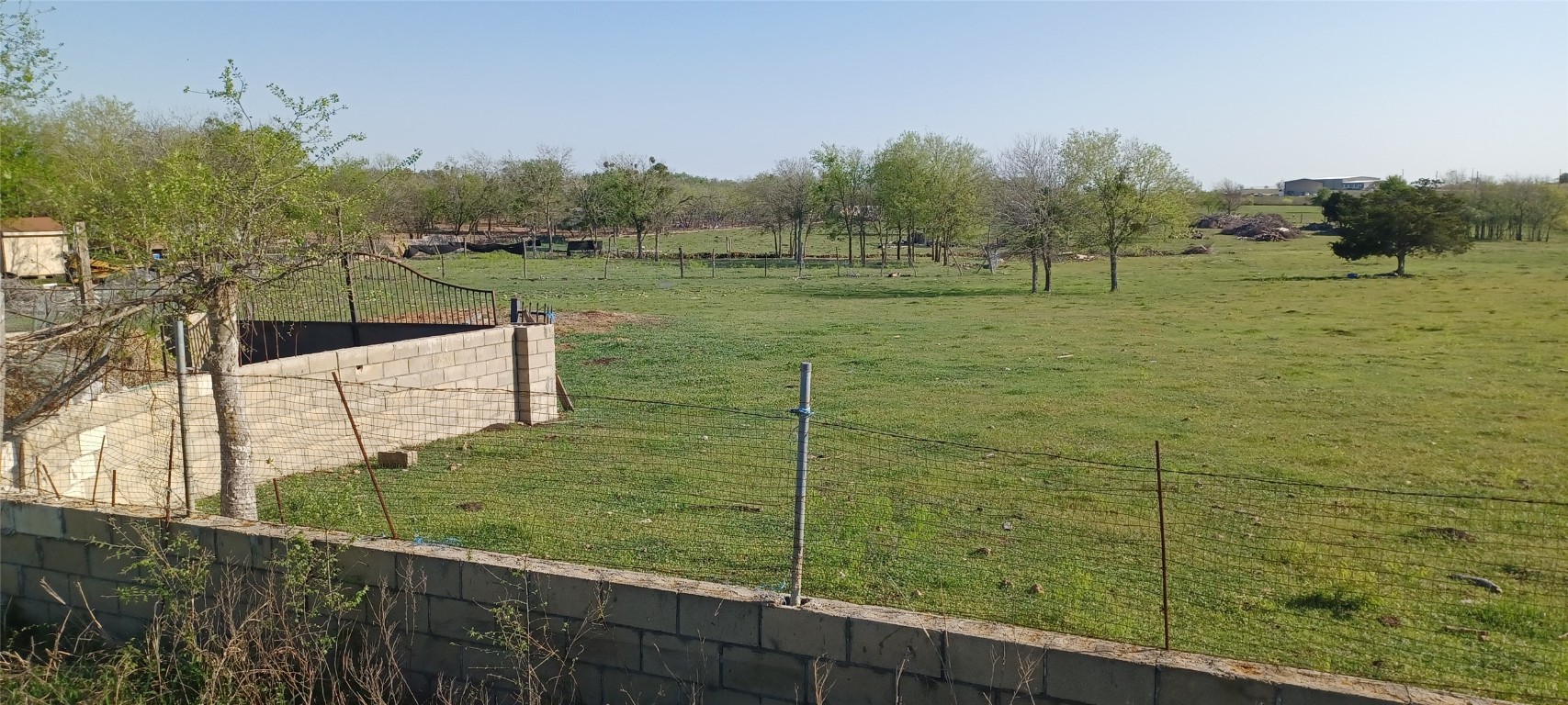 8424 Old Lockhart Road Buda, TX 78610 - Photo 2 of 3 a view of a wooden fence