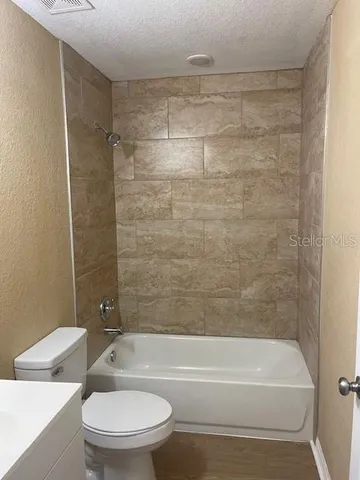 a bathroom with a bathtub and a toilet