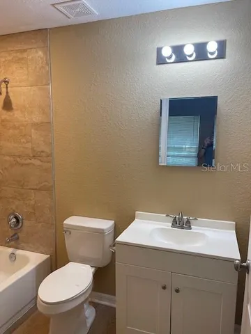 a bathroom with a bathtub and toilet