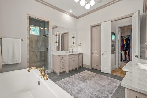a bathroom with a tub sink and mirror