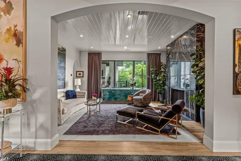 a living room with furniture and a chandelier