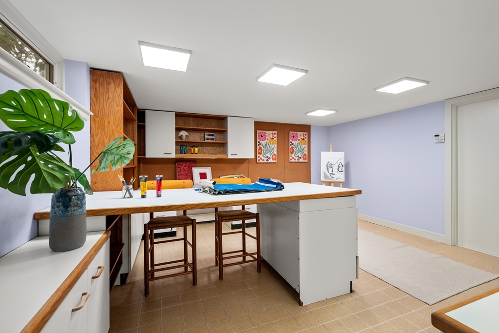 32 Moon Hill Road Lexington, MA 02421 - Photo 23 of 34 a room with stainless steel appliances kitchen island granite countertop a table chairs in it and wooden floor