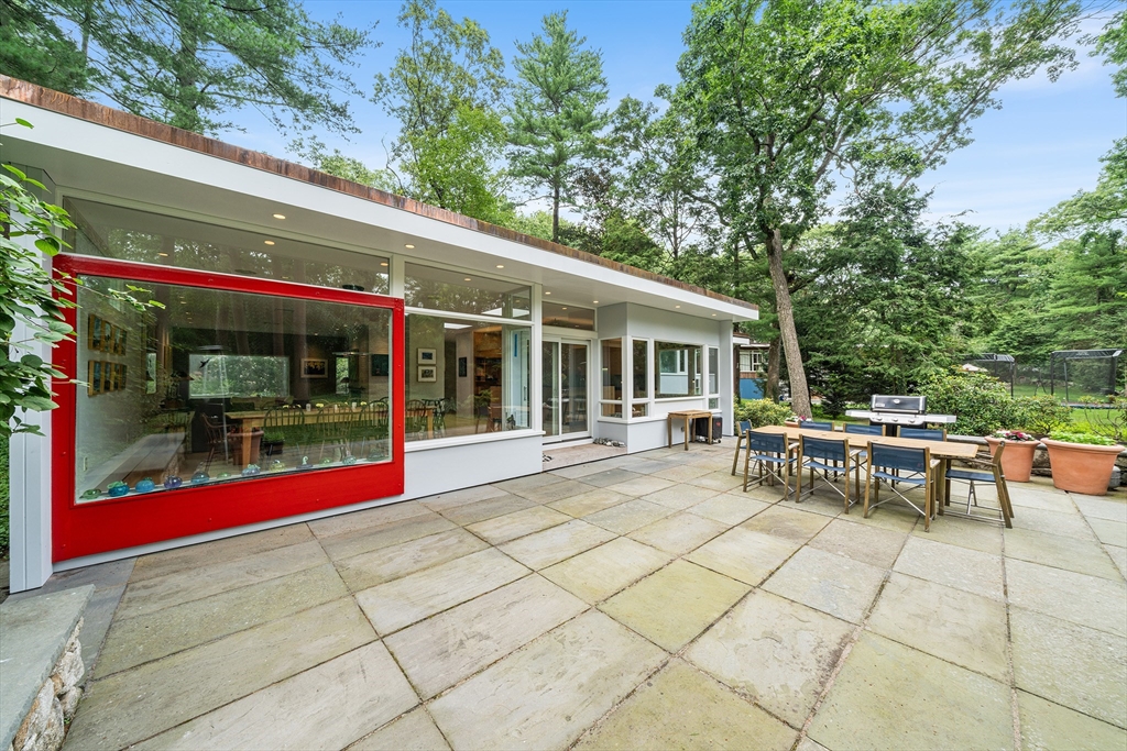 32 Moon Hill Road Lexington, MA 02421 - Photo 24 of 34 a view of a patio with table and chairs and potted plants