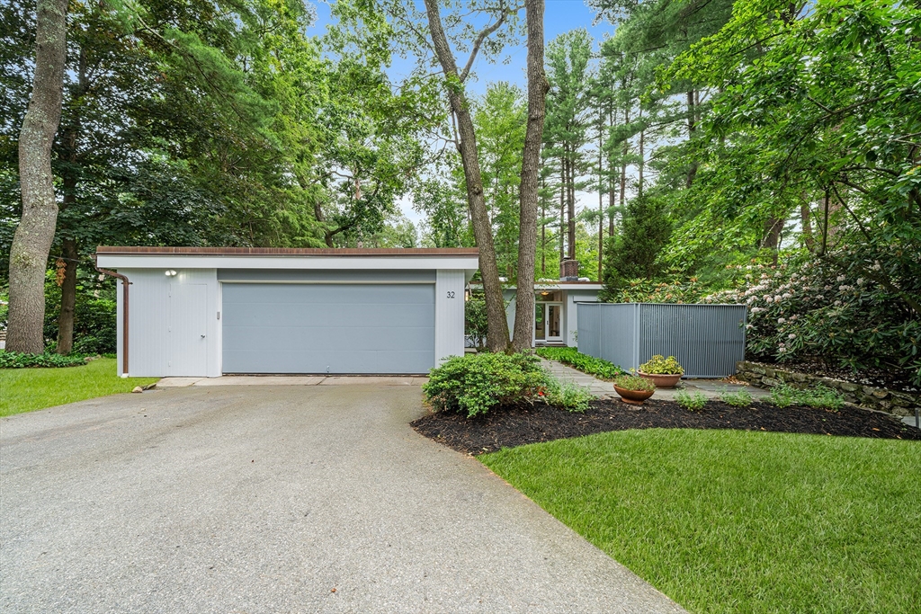 32 Moon Hill Road Lexington, MA 02421 - Photo 29 of 34 a view of a backyard with plants and a large tree