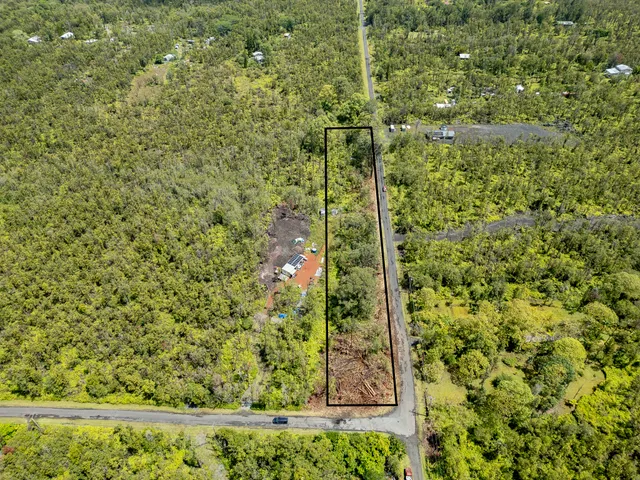 a view of a yard with a wooden fence