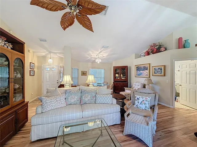 a living room with furniture and wooden floor